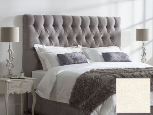 Lloyd bed shown in a stone colour harbour grey fabric, with a deep buttoned upholstered headboard.